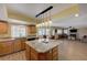 Open kitchen featuring granite counters, an island with pendant lighting, and wood cabinets at 1598 Bermuda Dunes Dr, Boulder City, NV 89005