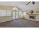 Cozy living room with fireplace, ceiling fan, and lots of natural light at 1598 Bermuda Dunes Dr, Boulder City, NV 89005
