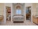 Main bathroom with spa tub, separate shower, double vanity, and ample natural light at 1598 Bermuda Dunes Dr, Boulder City, NV 89005