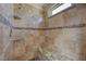 Custom tiled walk-in shower with granite seat and design accents at 1598 Bermuda Dunes Dr, Boulder City, NV 89005