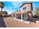 Landscaped backyard featuring a covered patio, rock ground cover, and mature trees at 1893 Donnington Ct, Las Vegas, NV 89123