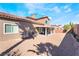 Spacious backyard boasts a covered patio, rock ground cover, and BBQ grill at 1893 Donnington Ct, Las Vegas, NV 89123