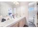 Functional bathroom features a double sink vanity and a shower/tub combination at 1893 Donnington Ct, Las Vegas, NV 89123