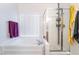 Bright bathroom featuring a shower with glass door and a soaking tub with tile surround at 1893 Donnington Ct, Las Vegas, NV 89123