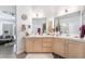 Spacious bathroom with double sinks, light-colored cabinetry, and wood-look floors at 1893 Donnington Ct, Las Vegas, NV 89123