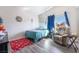 Serene bedroom with natural light, wood-look floors, and comfortable seating at 1893 Donnington Ct, Las Vegas, NV 89123