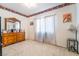 Comfortable bedroom with a dresser, soft carpet, sheer curtains, and bright, natural light at 1893 Donnington Ct, Las Vegas, NV 89123