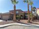 Stunning desert home showcasing a two-car garage and beautiful palm trees enhancing the curb appeal at 1893 Donnington Ct, Las Vegas, NV 89123