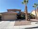 Charming two-story home with a two-car garage, beautiful desert landscaping, and mature palm trees at 1893 Donnington Ct, Las Vegas, NV 89123