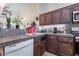 A bright kitchen featuring dark cabinets, white appliances and light colored countertops at 1893 Donnington Ct, Las Vegas, NV 89123