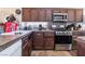 The kitchen features dark cabinets, stainless appliances and plenty of counter space at 1893 Donnington Ct, Las Vegas, NV 89123