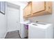 Laundry room featuring modern washer and dryer, plus overhead cabinet storage at 1893 Donnington Ct, Las Vegas, NV 89123