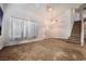 Spacious living room with neutral carpet, vaulted ceiling, and natural light at 1893 Donnington Ct, Las Vegas, NV 89123