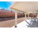 Covered patio features a table and chairs, and rock landscaping at 1893 Donnington Ct, Las Vegas, NV 89123