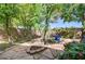 Charming backyard with lush greenery, stone paths, and garden accents at 2024 Riva Del Garda Pl, Las Vegas, NV 89134