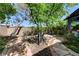 Lush backyard oasis with mature trees, stone pathways, and a cozy gazebo at 2024 Riva Del Garda Pl, Las Vegas, NV 89134