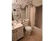 Bathroom features a shower-tub combo, floral wallpaper, and a vanity sink at 2024 Riva Del Garda Pl, Las Vegas, NV 89134