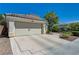 Exterior elevation of a single-story home featuring a well maintained yard and 2-car garage at 2024 Riva Del Garda Pl, Las Vegas, NV 89134