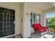 Charming front porch detail showcasing a cozy seating area and entrance at 2024 Riva Del Garda Pl, Las Vegas, NV 89134