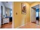 Hallway with wood floors and decorative art, leading to other rooms at 2024 Riva Del Garda Pl, Las Vegas, NV 89134