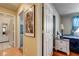 View of hallway with art and doors leading to a bathroom and bedroom with warm paint and floors at 2024 Riva Del Garda Pl, Las Vegas, NV 89134
