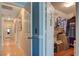 Hallway with hardwood floors leading to the rooms and a walk-in closet containing clothes and boxes on the right at 2024 Riva Del Garda Pl, Las Vegas, NV 89134