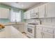 Well-lit kitchen with white cabinets, ample counter space, and modern appliances at 2024 Riva Del Garda Pl, Las Vegas, NV 89134