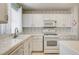 A bright kitchen featuring white cabinets and countertops at 2024 Riva Del Garda Pl, Las Vegas, NV 89134