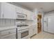 Well-lit kitchen features white cabinetry, modern appliances, and ample counter space at 2024 Riva Del Garda Pl, Las Vegas, NV 89134