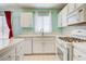 Clean kitchen featuring white appliances, ample counter space, and a window for natural light at 2024 Riva Del Garda Pl, Las Vegas, NV 89134