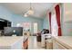 Bright living room with tile flooring, a ceiling fan, and a comfortable seating area at 2024 Riva Del Garda Pl, Las Vegas, NV 89134