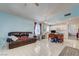 Open-concept living room and kitchen area with tile floors, comfortable sofa, and modern appliances at 2024 Riva Del Garda Pl, Las Vegas, NV 89134