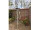 Outdoor windmill decoration adding a rustic touch to the backyard near the brick fence at 2024 Riva Del Garda Pl, Las Vegas, NV 89134