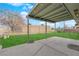 Covered back patio with a view of the fenced backyard and lush green grass at 2058 Citroen St, Las Vegas, NV 89142