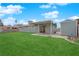 Spacious backyard featuring a covered patio and lush green grass at 2058 Citroen St, Las Vegas, NV 89142