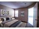 Bedroom featuring comfortable bed, neutral walls, and natural light, with an attached room at 2300 E Silverado Ranch Blvd # 1180, Las Vegas, NV 89183