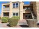 Tan condo building with stairs leading to the second floor and well-maintained landscaping at 2300 E Silverado Ranch Blvd # 1180, Las Vegas, NV 89183