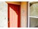 Close-up of a brightly painted front door with house number and nearby window at 2300 E Silverado Ranch Blvd # 1180, Las Vegas, NV 89183