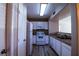 A bright kitchen featuring white appliances, granite countertops, and wood-look floors at 2300 E Silverado Ranch Blvd # 1180, Las Vegas, NV 89183