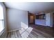 Bright living room with stylish wood floors and a large window for natural light leading into the kitchen at 2300 E Silverado Ranch Blvd # 1180, Las Vegas, NV 89183