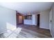 Bright living room with stylish wood floors and a large window for natural light leading into the kitchen at 2300 E Silverado Ranch Blvd # 1180, Las Vegas, NV 89183