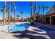 Beautiful swimming pool area with surrounding palm trees and a spa at 2300 E Silverado Ranch Blvd # 1180, Las Vegas, NV 89183