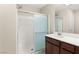 Bright bathroom with a glass-enclosed shower, a single sink vanity, and modern fixtures at 2409 Bellinzona Pl, Henderson, NV 89044