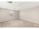 Bright bedroom featuring neutral carpet, ceiling fan, and window at 2409 Bellinzona Pl, Henderson, NV 89044