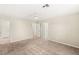 Bright bedroom featuring neutral carpet, ceiling fan, and ensuite bathroom and walk-in closet at 2409 Bellinzona Pl, Henderson, NV 89044