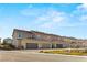 A wide view of townhomes with garages and desert landscaping under a blue sky at 2409 Bellinzona Pl, Henderson, NV 89044