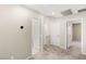 Carpeted hallway featuring multiple white doors leading to rooms and a thermostat on the wall at 2409 Bellinzona Pl, Henderson, NV 89044