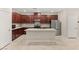 Modern kitchen featuring granite countertops, an island with breakfast bar, and stainless steel appliances at 2409 Bellinzona Pl, Henderson, NV 89044