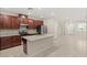 Spacious open layout with a kitchen island, granite countertops, stainless steel appliances and cherry wood cabinetry at 2409 Bellinzona Pl, Henderson, NV 89044