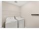 Functional laundry room featuring a washer, dryer, and overhead storage shelf at 2409 Bellinzona Pl, Henderson, NV 89044
